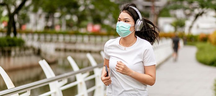 woman withg mask jogging